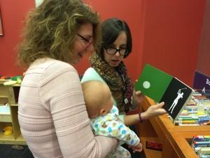 Karen and Morgan read a high-contrast book on baby