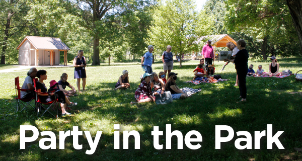 People sitting on a green lawn