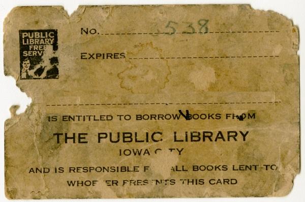 a water-stained, tattered, faded paper square, an Iowa City Public Library card from the early 1900s